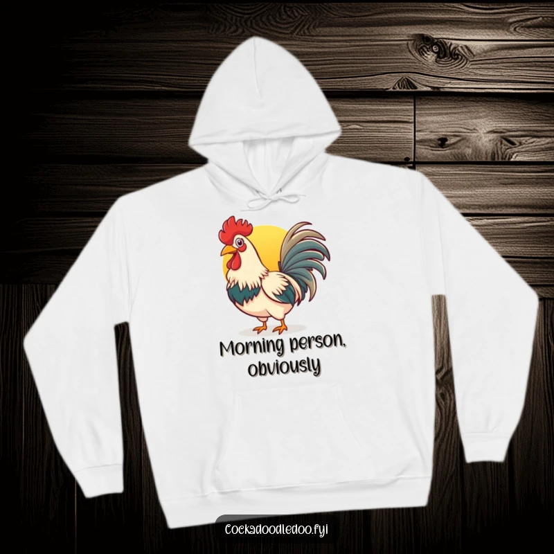 Funny rooster hoodie featuring a cheerful bird with a wide beak crowing energetically at the beautiful rising sun.